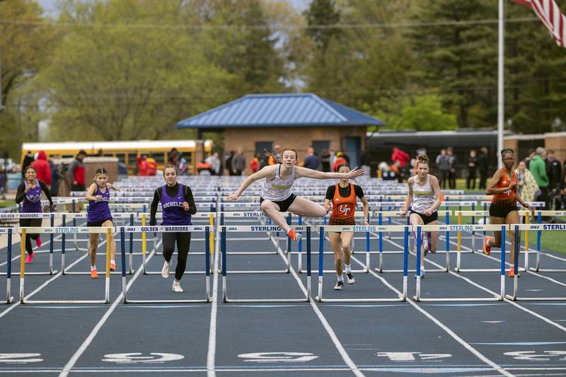 Sterling Abby Ryan clears the last hurdle in the 100 meter Friday, May 2, 2025, at the Sterling Night Relays.