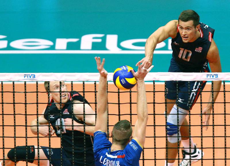 Thomas Jaeschke (right) has an attacking hit for USA Volleyball in an FIVB World League match in 2015. Jaeschke, who helped lead Wheaton Warrenville South to a state title and Loyola University of Chicago to two national titles, is competing in his second Olympics this year in Tokyo.