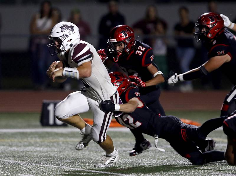Huntley's Michael Chan breaks away fromm the tackle attempt of Huntley's Oluwaseun Oladipo and Huntley's Dechawn Jones (32) as he runs for a touchdown during a Fox Valley Conference football game on Friday, Oct. 3, 2025, at Huntley High School.