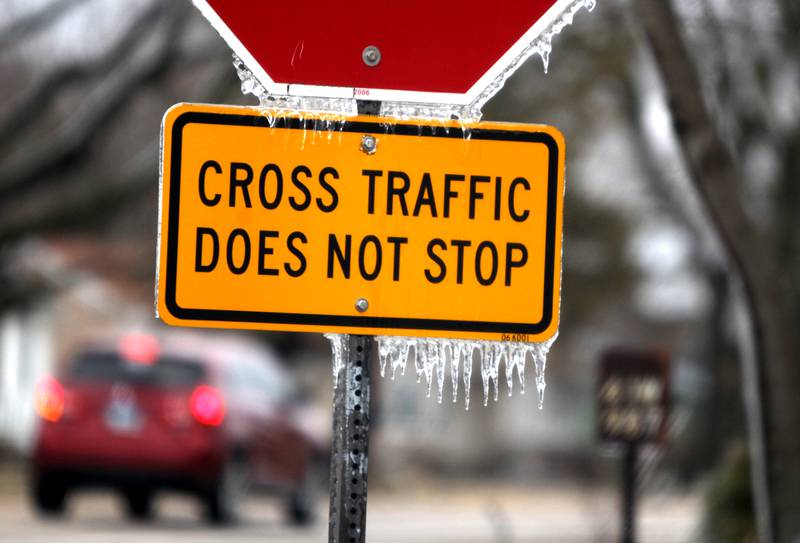 Ice covered trees and dripped from signs in western Kane County after a storm on Thursday, Feb. 23, 2023.