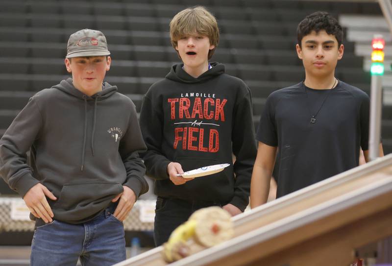 LaMoille students Zane Sundberg, Dominic Steele, Easton Zamora watch their car race down the ramp during the Edible Car Contest on Wednesday, Feb. 25, 2026 at Illinois Valley Community College in Oglesby.