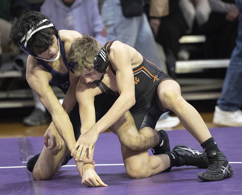 Dixon’s Riley Paredes (left) works against Freeport’s Treyden Diduch Tuesday, Jan. 13, 2025, during a triangular meet with Sterling at Dixon High School.