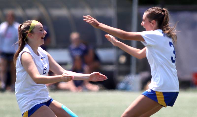 Johnsburg’s Devynn Michel, left, greets Charlie Eastland after an Eastland penalty kick goal clinched a win over Willows Academy in IHSA Class 1A Supersectional soccer action at Dominican University in River Forest on Saturday, May 31, 2025.