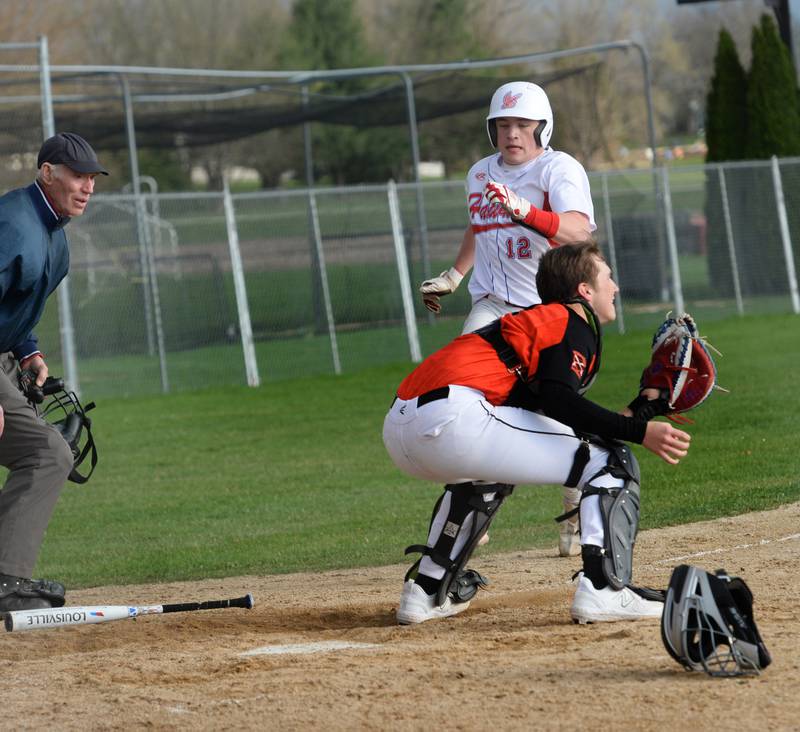Oregon's Gavin Morrow races to home ahead of the throw to score a run during an April 20 game against Winnebago.