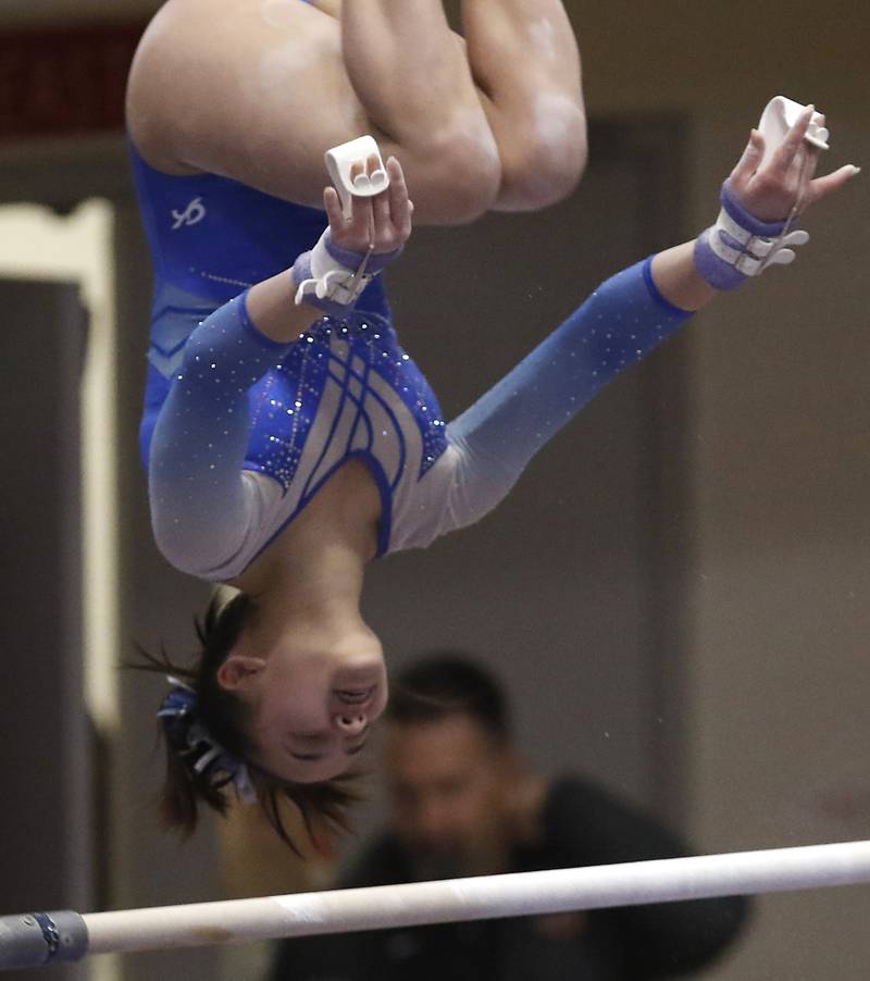 Vernon Hills' Livy Tran competes in the preliminary round of the uneven parallel bars Friday, Feb. 17, 2023, during the IHSA Girls State Final Gymnastics Meet at Palatine High School.