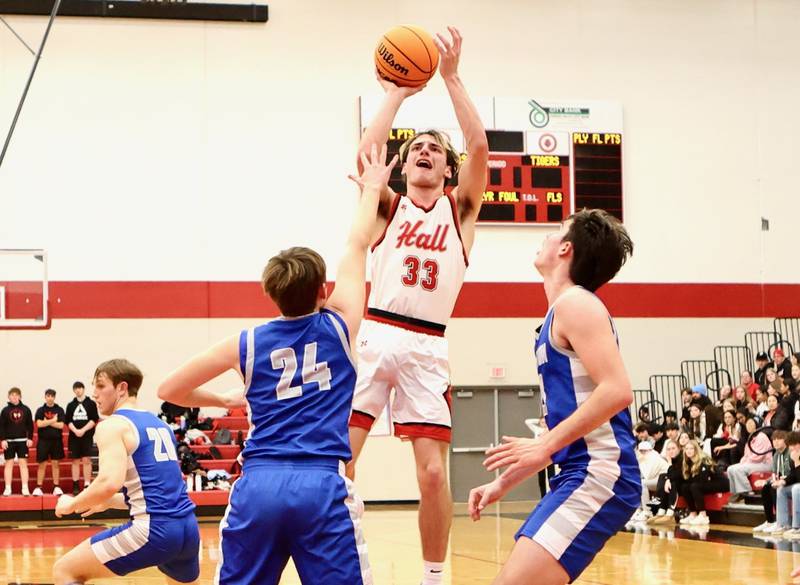 Hall's Braden Curran shoots over Princeton's Ryan Jagers (24) and Noah LaPorte Friday night at Hall High School. The Red Devils won 62-54.