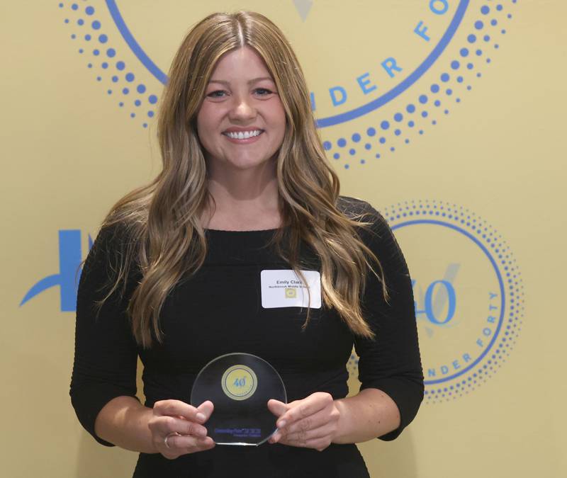 Emily Clark poses with her 40 Under Forty award during the Illinois Valley Chamber of Commerce Champions of Change Awards Night on Wednesday, May 6, 2026 at the Westclox Event Center in Peru.
