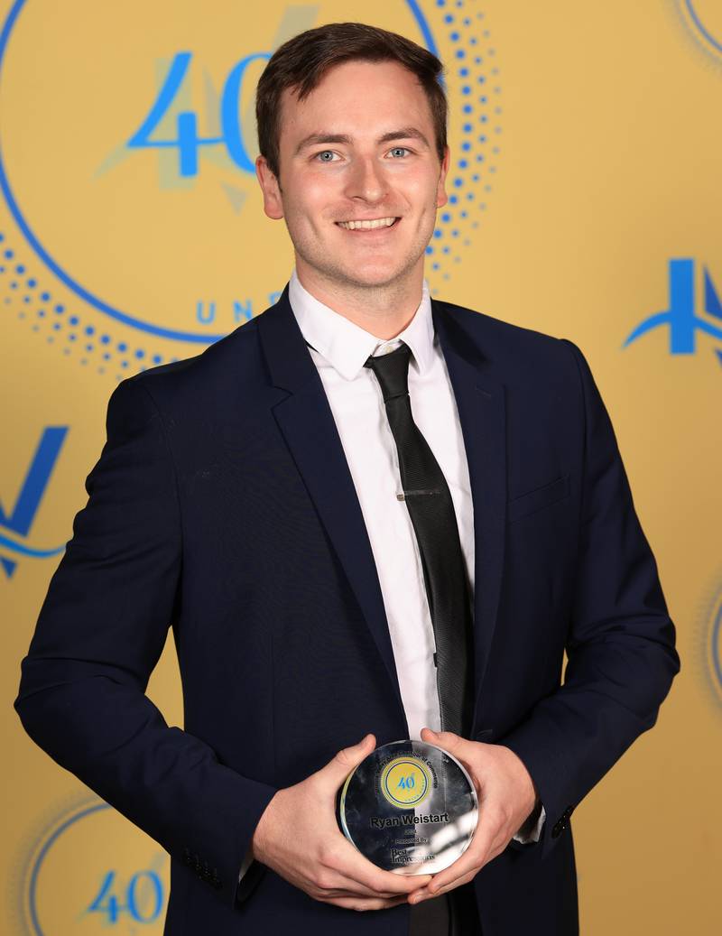 Ryan Weistart poses with his 40 Under Forty award during the Illinois Valley Chamber of Commerce Champions of Change Awards Night on Thursday, April 10, 2025 at the Westclox Event Center in Peru.