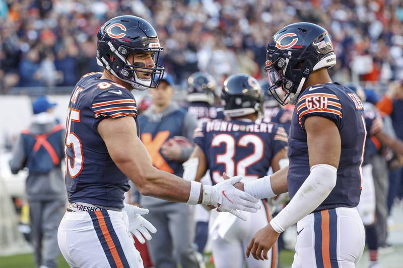Chicago Bears tight end Cole Kmet, left, celebrates with quarterback Justin Fields after scoring a touchdown against the Miami Dolphins, Sunday, Nov. 6, 2022, in Chicago.