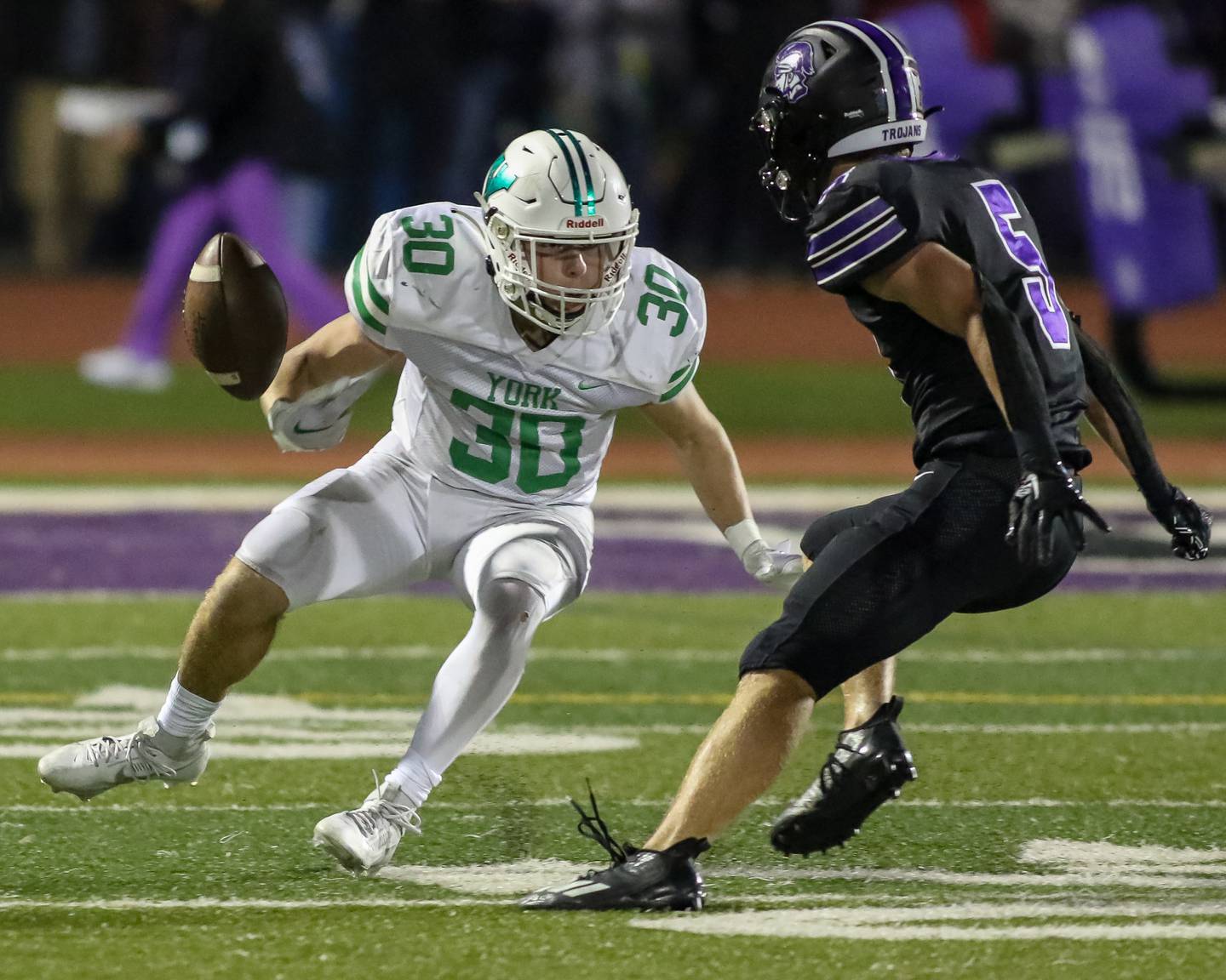 York's Jake Mellon (30) looses the ball out of bounds while being pursued by Downers Grove North's Owen Thulin (5) during football game between York at Downers Grove North.  Sept 29, 2023.