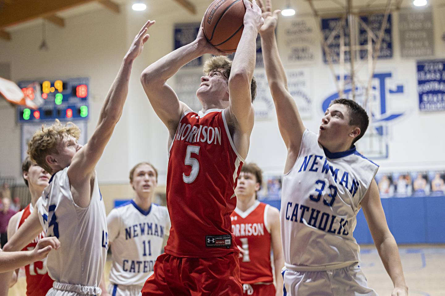 Morrison’s Chase Newman puts up a shot against Newman’s Lucas Simpson (left) and Evan Bushman  Wednesday, Jan. 3, 2024 at Newman High School.