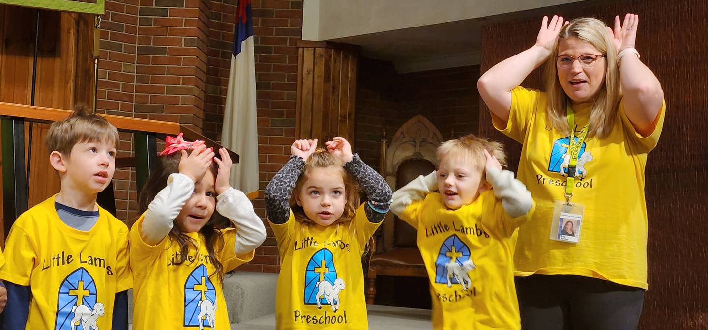 Students and an instructor sing a silly song at Little Lambs Preschool of Immanuel Lutheran Church in DeKalb.