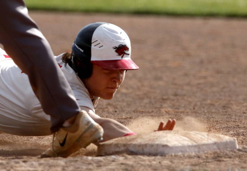 Huntley's Tommy Gasner dives back to first base during a Fox Valley Conference baseball game against Huntley on Tuesday, May 8, 2026, at Huntley High School.