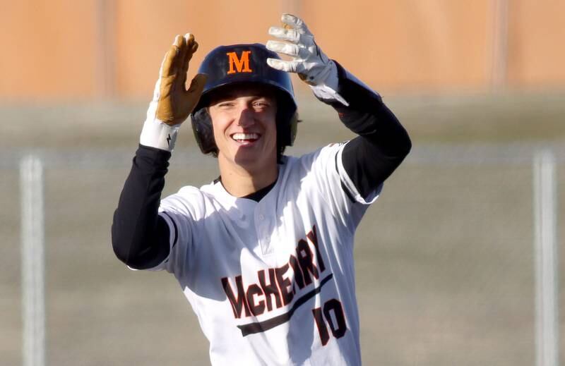 McHenry’s Jeffry Schwab celebrates at second base after connecting for a double against Huntley in varsity baseball at McHenry Friday night.