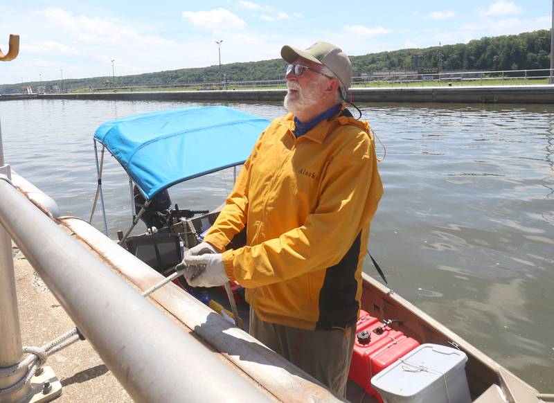 71 year old adventurer and thyroid cancer survivor Robert Youens, smiles while locking at the Starved Rock Lock and Dam on Monday, July 28, 2025 near Utica. Youens is making  the Great Loop, a 6,000 mile journey on his Jon boat something that hasn't been done before. Youens is looking at setting a record for the longest someone has gone on a Jon boat. Youens has 84 gallons of fuel and no cooler. He sleeps on the boat at night with a planned 7-hour rest.