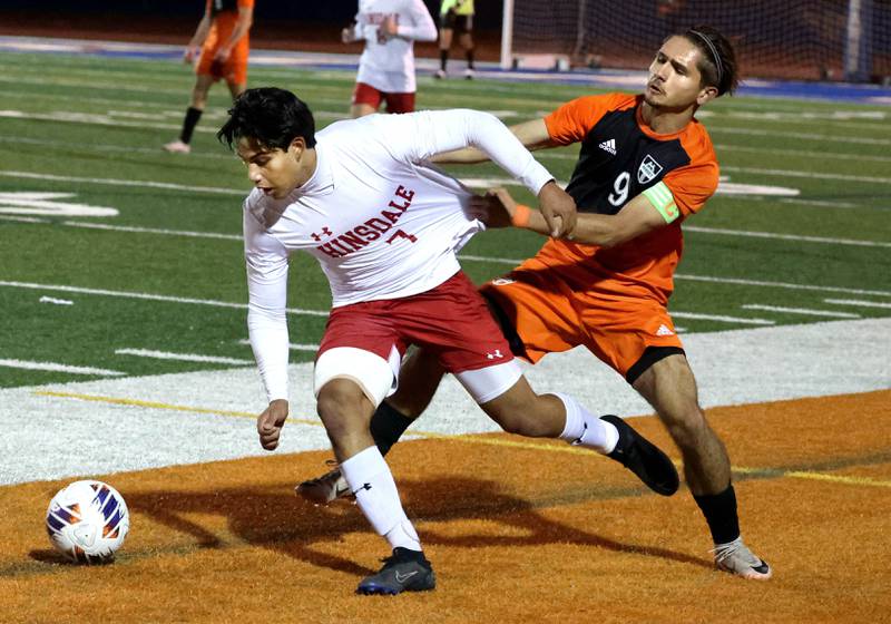 Hinsdale Central's Enzo Cinque tries to pull away from Hersey's Ray Reyes Friday, Nov. 8, 2024, during their Class 3A state semifinal game at Hoffman Estates High School.