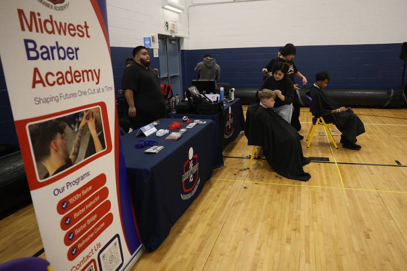 Kids get free hair cuts from Midwest Barber Academy during the Will County’s annual Kids Fair at Troy Middle School on Monday, Feb. 16, 2026 in Joliet.