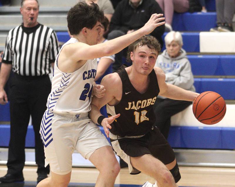 Burlington Central’s Matthew Lemon (left) keeps up with Jacobs’ Jackson Martucci in varsity boys basketball at Burlington Tuesday night.