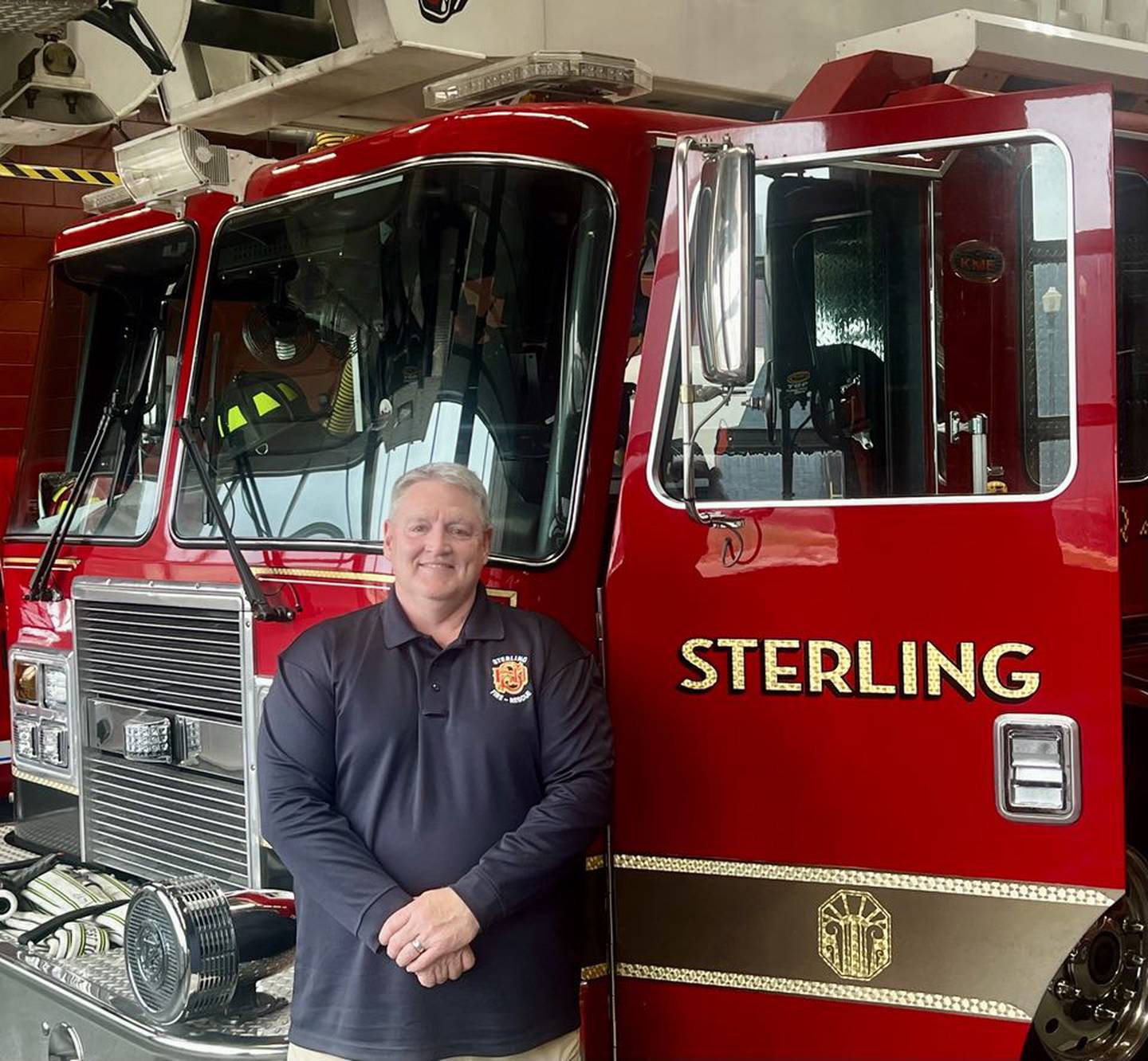 Newly appointed Fire Chief David Northcutt stands beside a fire engine at the Sterling Fire Department.