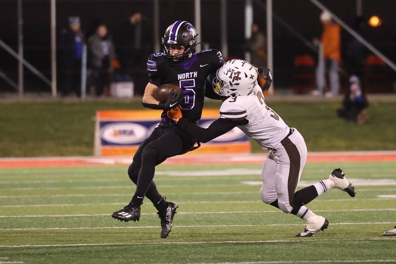 Downers Grove North’s Owen Thulin fights off a defender after a catch against Mt. Carmel in the Class 7A championship on Saturday, Nov. 25, 2023 at Hancock Stadium in Normal.