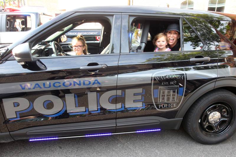 Kara Middleton, of Wauconda and her daughters, Charlotte, 4, and Annabelle, 2, check out Wauconda Police squad car 116 during National Night Out on Main Street on Tuesday, August 1st in Wauconda.  
Photo by Candace H. Johnson for Shaw Local News Network.