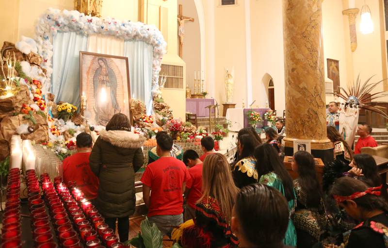 Parishioners pray during the Lady of Guadalupe event on Tuesday, Dec. 12, 2023 at St. Hyacinth Church in La Salle. Our Lady of Guadalupe, also known as the Virgin of Guadalupe, is a Catholic title of Mary, mother of Jesus.