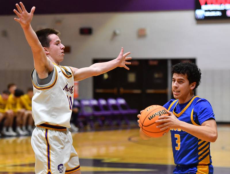 Lyons Township’s Dylan Holcer (3) starts to pass as Downers Grove North’s Connor Crowley defends during a game on January 15, 2026 at Downers Grove North High School in Downers Grove .