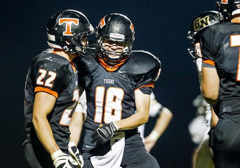 Crystal Lake Central's Ryan Willliams (left) celebrates with Justin Wagner after scoring a touchdown in the second quarter of the boys football game Thursday in Crystal Lake. Crystal Lake Central beat Grayslake North, 37-34.