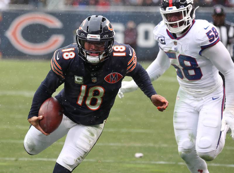 Chicago Bears quarterback Caleb Williams carries the ball down to the one-yard-line ahead of New York Giants linebacker Bobby Okereke Sunday, Nov. 9, 2025, during their game at Soldier Field in Chicago.