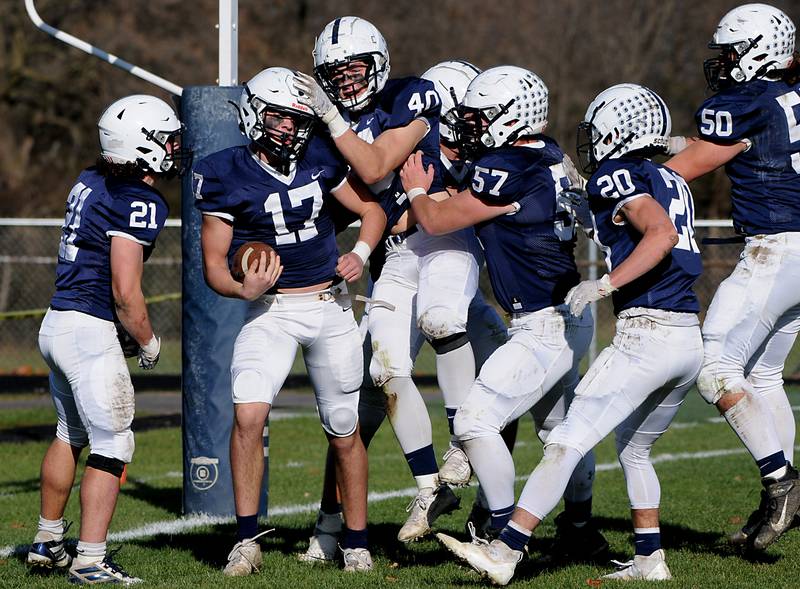 Cary-Grove's Jameson Sheehan celebrates a touchdown with his teammates during first quarter of the IHSA Class 6A semifinal football game against Lake Forest Saturday afternoon, Nov. 20, 2021, at Cary-Grove High School.