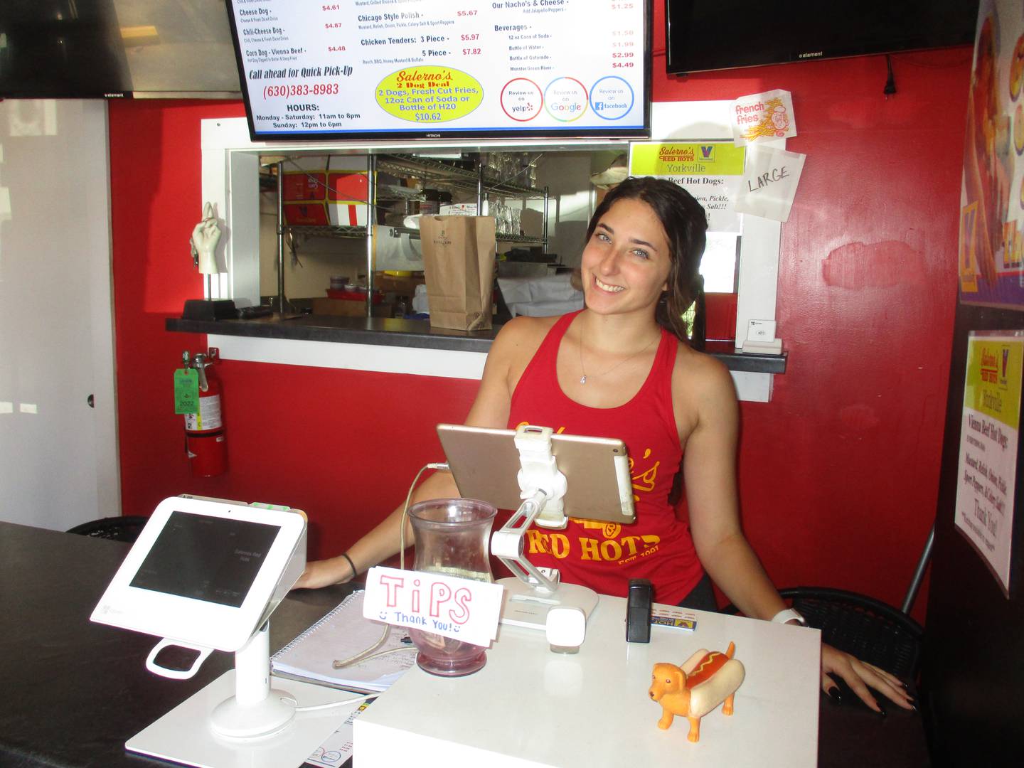 Gianna Davis of Yorkville greets customers at Salerno's Red Hots. The popular shop is rated as one of the best hot dog spots in Illinois. (Mark Foster -- mfoster@shawmedia.com)