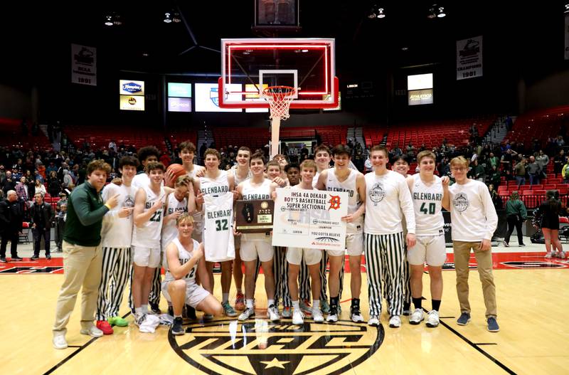 Glenbard West players celebrate the team’s Class 4A DeKalb Supersectional game win over Larkin at the Northern Illinois University Convocation Center on Monday, March 7, 2022.