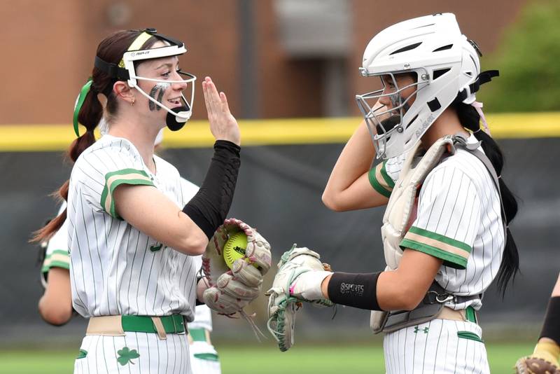 Seneca's Hayden Pfeifer, left, high fives Lexie Buis before the final inning of the Fighting Irish's 11-0 win over Reed-Custer in the Class 2A Regional semifinals Tuesday, May 19, 2026.