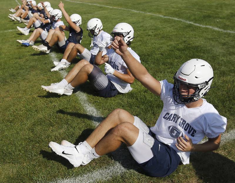 Cary-Grove's Oliver Antonelli (right) and  Brady Elbert (2nd to right) do conditioning drills during Cary-Grove’s first football practice of the upcoming season on Monday, August 11, 2025, at Cary-Grove High School.
