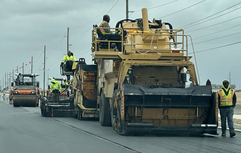 Crews from Advanced Asphalt pave the final coat of asphalt on Plank Road on Tuesday, Oct. 21, 2025 in Peru. The first of three phases of Plank Road construction have been compleated The temporary stoplights have been removed from the construction zone. The project involved a new turn lane, wider lanes in both directions, curb and gutter, and addition of a recreation trail. Future plans are to reconstruct the road all the way to Interstate 80.
