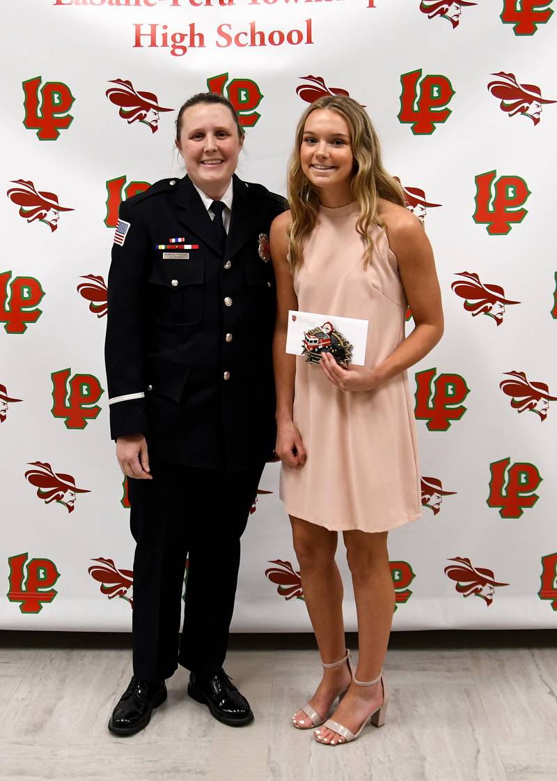 Mallory Freeman (right) received the Gary Eccles Scholarship, presented by fire science teacher Robbyn Partain (left). The $500 scholarship is awarded to an L-P senior going into emergency services and who will attend IVCC.