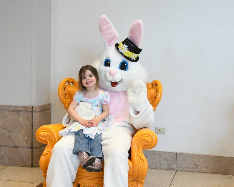 Evie Dilday, 3, of West Chicago is all smiles as she pose for a photo with the Easter Bunny at the Easter Egg hunt event held at Cantigny Park in Wheaton on Sunday March 24, 2024.