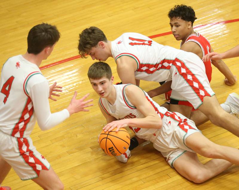 L-P's Gavin Stokes falls on a loose ball as teammates John Sowers and Jameson Hill help him out while Ottawa's Hezekiah Joachim watches the ball from the bottom of the pile during the Class 3A Regional title game on Wednesday, Feb. 25, 2026 in Sellett Gymnasium at L-P High School.