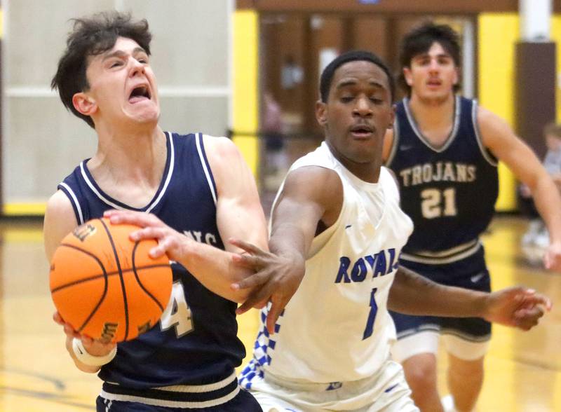 Cary-Grove’s Dylan Dumele, left, is fouled by Larkin’s Jaevon Ligon, right, in varsity boys basketball Hinkle Holiday Classic action on Friday, Dec. 26, 2025, at Jacobs High School in Algonquin.
