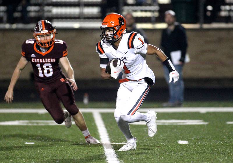 Wheaton Warrenville South's Reece Young (1) carries the ball during a Class 7A first-round playoff game against Brother Rice in Chicago on Saturday, Oct. 30, 2021.