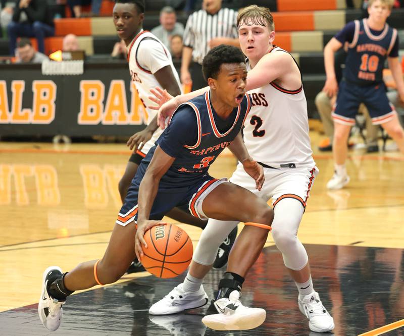 Naperville North's Bryce Welch tries to get around DeKalb’s Sean Reynolds during their game Friday, Dec. 8, 2023, at DeKalb High School.