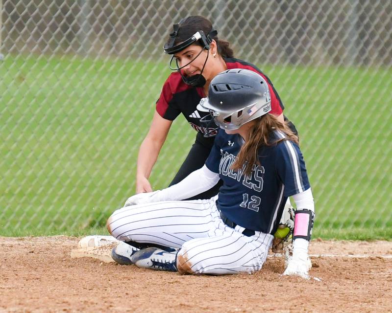 Oswego East’s Kaitlyn Maday (12) slides into third base and called safe as Plainfield North Sophia Feminis(20) tries to take her out during the game on Thursday April 17, 2025, held at Oswego East High School.