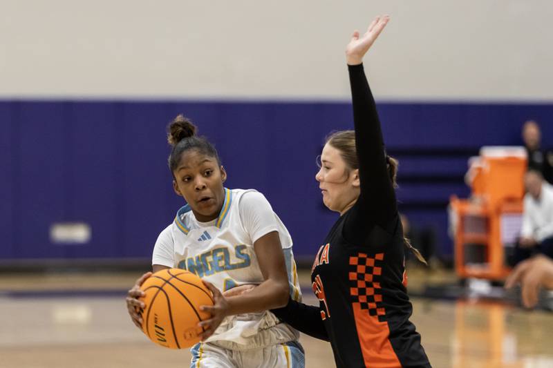 Joliet Catholic's Laylah Carroll goes head to head with Minooka's Cailyn Obrien during a WJOL Girls Basketball Tournament game at Joliet Junior College on Nov. 17, 2025.