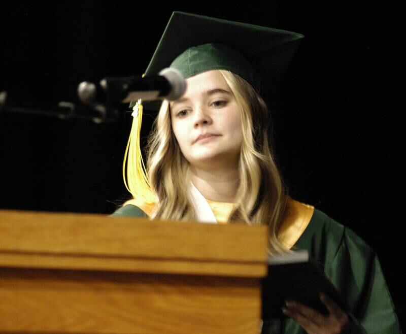 Salutatorian Ava Henson steps to the microphone to address her class. Rock Falls High School held the Class of 2024 commencement at Tabor Gym at Rock Falls High School on Sunday, May 26, 2024.