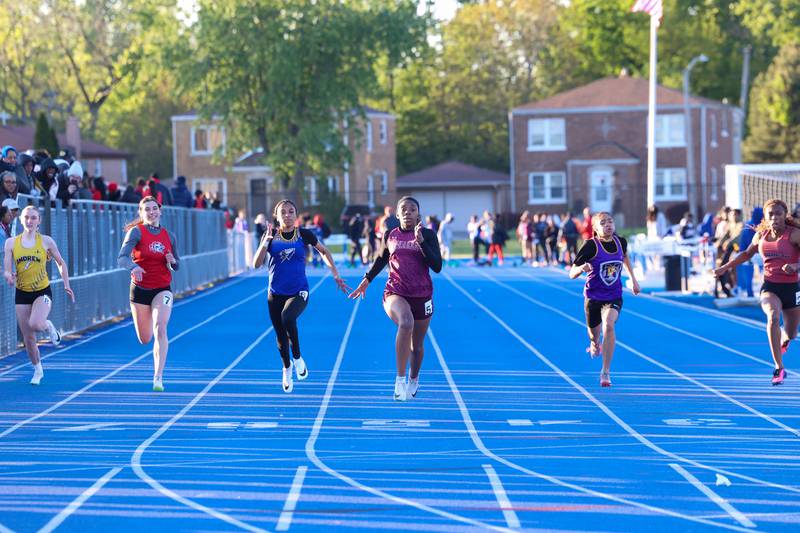 Kankakee's Jemya Williams, center, leads her heat in the 100-meter dash during the IHSA Class 3A Chicago Heights Girls Track and Field Sectional at Bloom High School on Wednesday, May 13, 2026. Williams tied for sixth overall with a 12.36-second time, narrowly missing the state qualifying of 12.32 sdeconds.