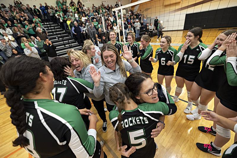 Rock Falls volleyball head coach Sheila Pillars (left) celebrates with her team after beating Chicago Christian in two sets Friday, Nov. 3, 2023 in the class 2A volleyball supersectional in Sandwich. The Rockets will play next weekend for the state title.