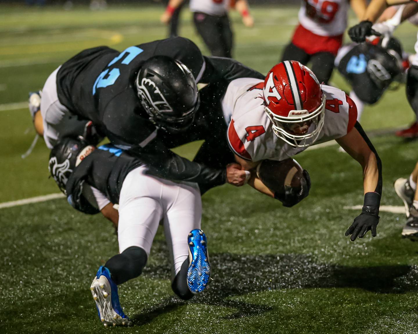 Willowbrook's Josh Puknaitis (53) and Martin Anfinson (8) combine on a tackle of Yorkville's Josh Gettemy (4) during Class 7A football playoff game between Yorkville at Willowbrook.   Oct 27, 2023.