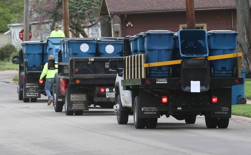 City of Princeton crews distribute new garbage totes along First Street Monday, April 29, 2024 in Princeton.