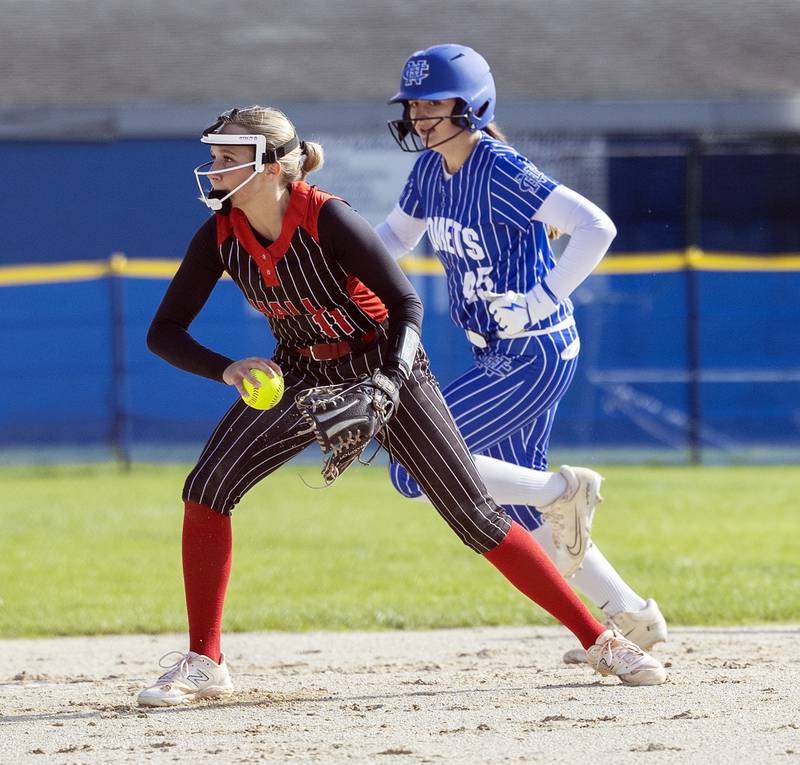 Hall’s Charlie Pellegrini shovels to third for an out against Newman Monday, April, 21, 2025.