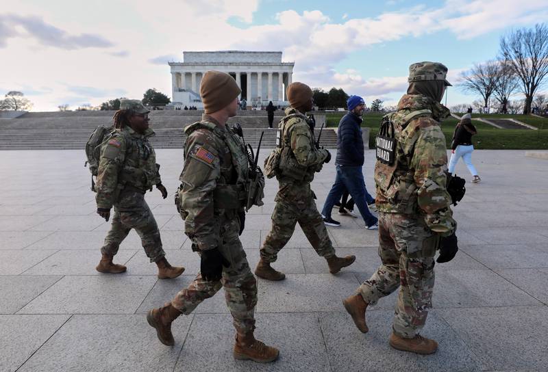 National Guard patrol the National Mall near the Lincoln Memorial, Friday, Nov. 28, 2025, in Washington. (AP Photo/Rahmat Gul)
